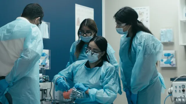 Dr. Kraishan and a group of students working together during a bench-exam training session.
